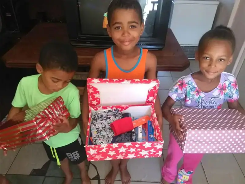 Children opening Christmas gifts