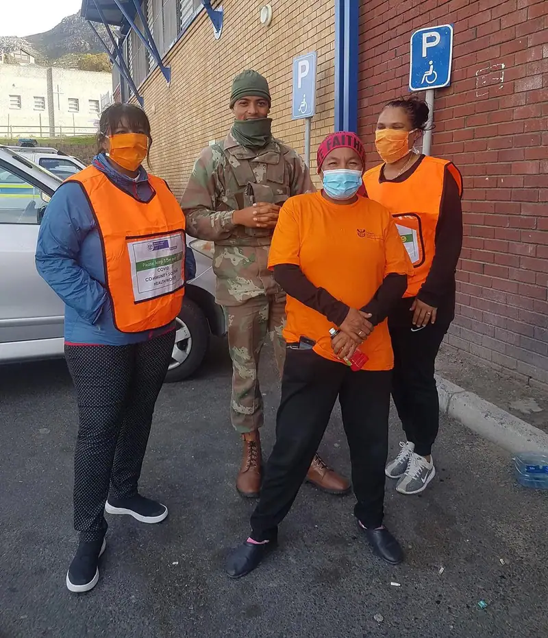 Volunteers in high-visibility vests during community health testing