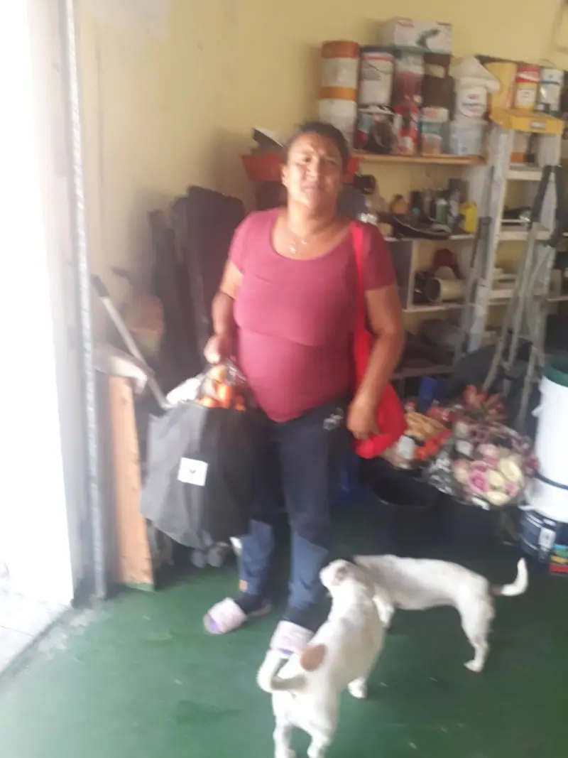 A woman collecting a food parcel at Hangberg Dreams