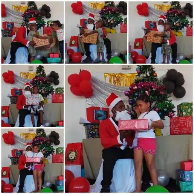 Children receiving gifts from Santa at the Christmas party