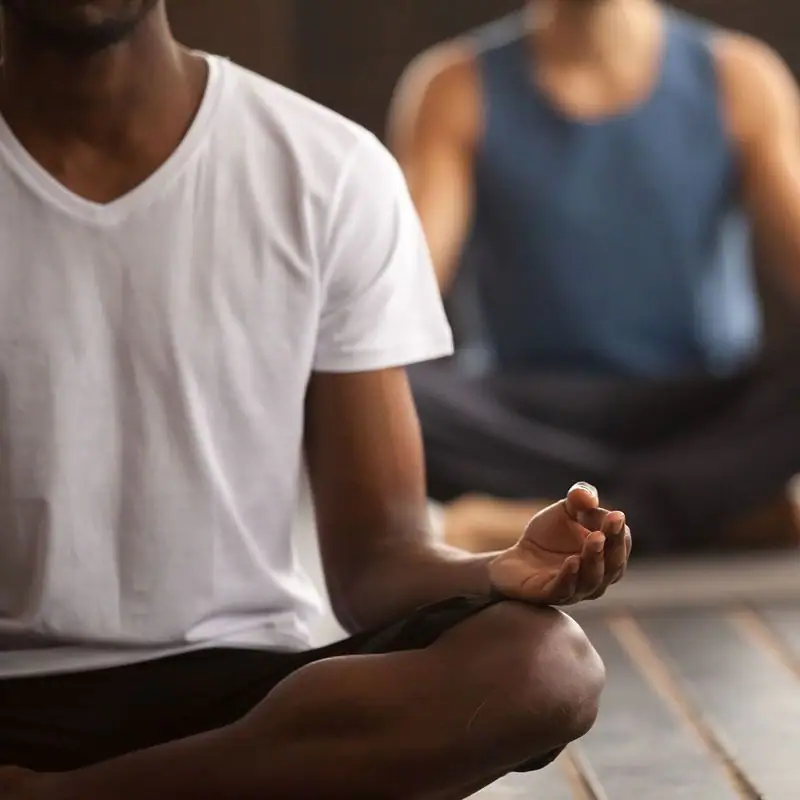 A person sitting cross-legged in a yoga pose