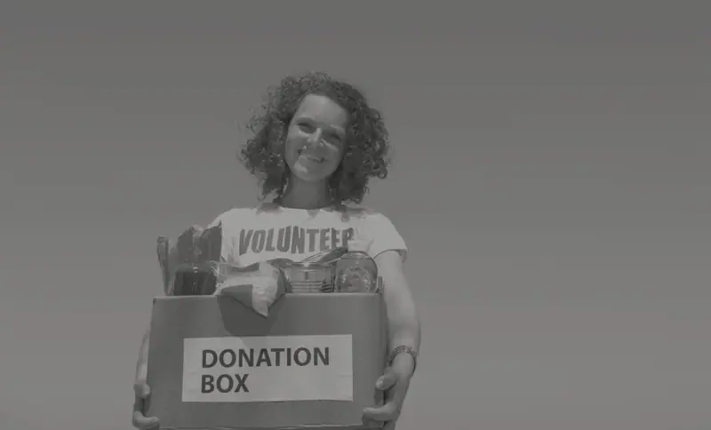 A woman holding a donation box